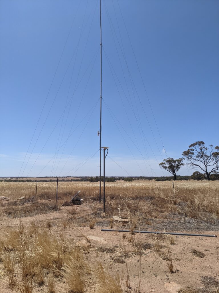 An antenna in a field that is being used to connect farm monitoring devices to the internet.